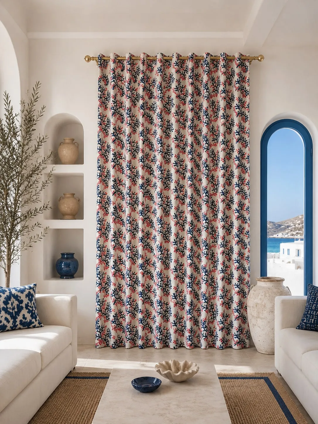 A patterned embroidered curtain drawn beside a tall window.